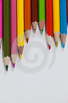 Close-up of colored pencils arranged in a wave pattern