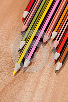 Close-up of colored pencils arranged in a wave pattern