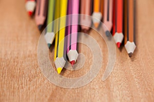 Close-up of colored pencils arranged in a wave pattern