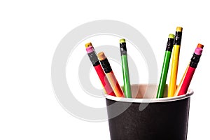 Close up colored pencils in paper glass isolated on white background. Business