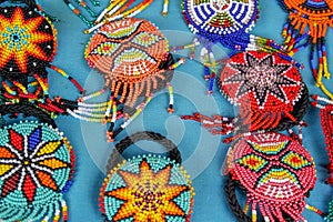 Close up of colorful beaded traditional hairpieces sold at the Otavalo market, Ecuador, handmade