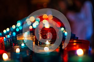 Close up of colorful candles in a dark spiritual scene. Commemoration, funeral, memorial. Religious symbolism photo