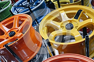 Close-up of colorful car alloy wheels in a garage