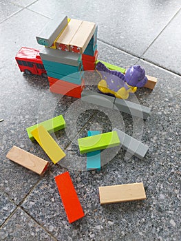 Close-up of colorful children\'s toys scattered on the floor.