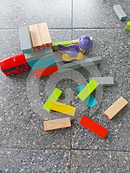 Close-up of colorful children\'s toys scattered on the floor.