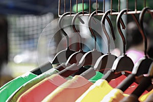 Close up colorful clothes hanging, Colorful t-shirt on hangers or fashion clothing on hangers