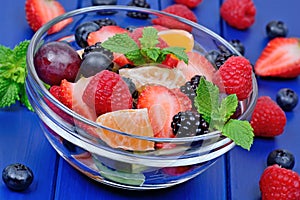 Colorful fruit salad in a transparent bowl