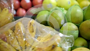 Close-up of colorful fruit stand with pears, kiwis, apples, and more