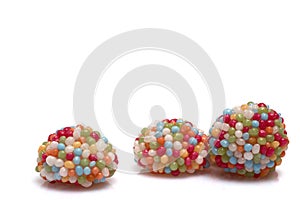 Closeup gum candy balls topping white background