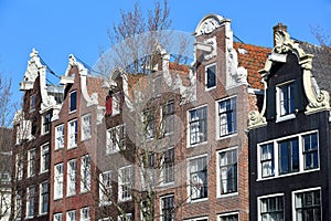 Close-up on colorful heritage buildings with gable rooftops, located along Brouwersgracht Canal in Amsterdam