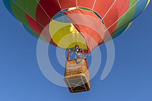 Close up of colorful hot air balloon heading up in blue sky