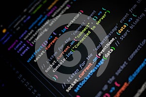 Close-up of colorful JavaScript code on computer screen, showing socket connection and server communication for modern web