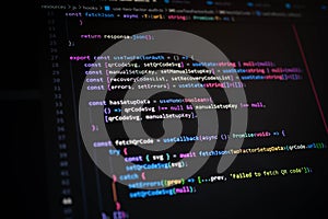 Close-up of colorful JavaScript code on dark screen showing two-factor authentication logic, used in web development, programming