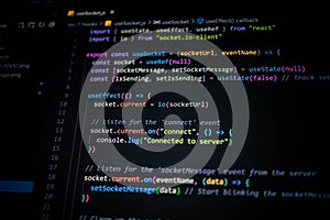 Close-up of colorful JavaScript and React code on computer screen, showing socket connection and server communication for modern