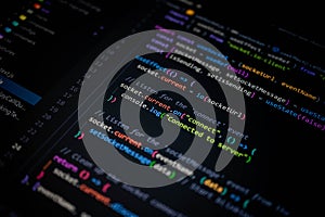 Close-up of colorful JavaScript source code on computer screen, showing socket connection and server communication for modern web