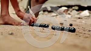 Close up of a colorful marbles and playing child.