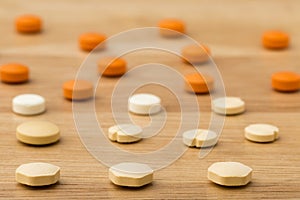 Close up colorful medical pills on wooden