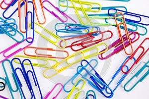 Close-up colorful paperclips on white background