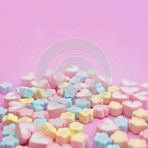 Close-up colorful pastel sweet color of marshmallows on pink background with copy space