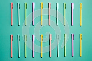 Close up of colorful pencils over the green background.