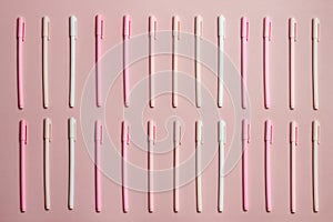 Close up of colorful pencils over the pink background.