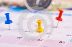Colorful pin on calendar for business appointment or planning concept photo