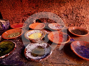 Close up of colorful, powdered dyes on plates in the souk of Marrakech. Dried colors in the Medina, Morocco.