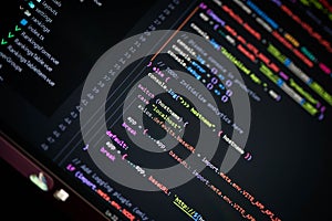 Close-up of colorful programming code showing switch case with hostname localhost and axios.defaults.baseURL for API configuration
