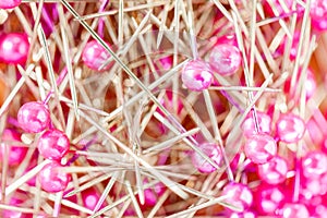 Close up colorful sewing pins pile and reflection.