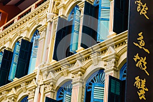 Close-up of Colorful Shutters and Caligraphy Sign in Chinatown, Singapore photo