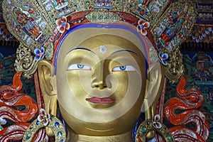 Colorful statue of Maitreya Buddha at Tibetan Buddhist Thiksey Monastery near mountain village Leh in ladakh region, north India