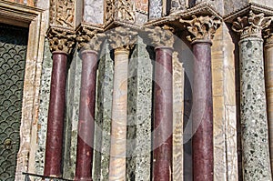 Close-up of columns and capitals made of various types of marble on the San Marco Basilica facade at Venice.
