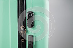 Close-up of a combination lock of a mint plastic suitcase.