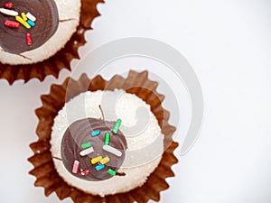 Close up of comfit or sweets with sprinkles in white background