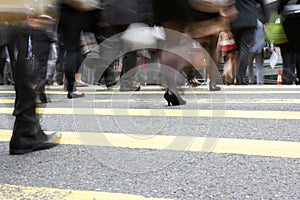 Close Up Of Commuters Feet Crossing Busy Street