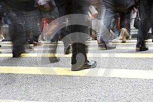 Close Up Of Commuters Feet Crossing Busy Street