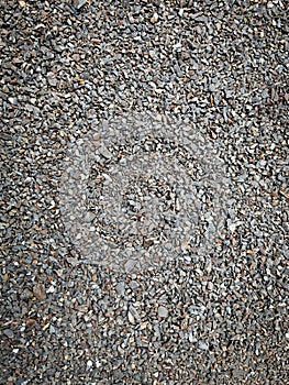 Close-up of compact gravel stones in mixed earth tones.