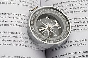 Close-up of compass on book