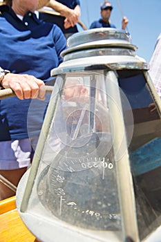 Close-up of compass on sailboat's helm