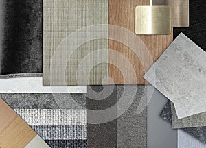 close up composition of interior material samples in shades of gold grey and black contains stainless, drape, concrete texture