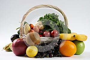 Close-up composition with vegetables and fruit in wicker basket