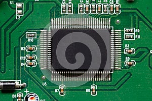 Close-up of computer chip on green pc motherboard microchip