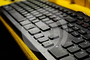 Close up computer keyboard on wooden desk