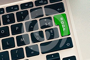 Close up of computer laptop keybord with green button. RGDP on a green key concept. Internet data and cyber crime security photo