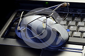 Close up computer mouse with glasses