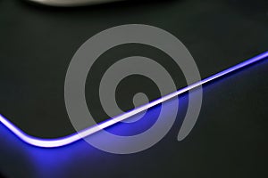 Close up of Computer RGB gaming mouse pad, Illuminated by colored LED