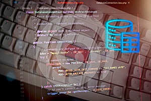 Close-up of computer source code on transparent overlay above keyboard, illustrating server-side development, data processing, and