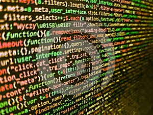 Close up of computer web page code inside of html file. Developer working on source codes on computer at office. Lines of code of
