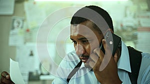 Close-up concentrated detective talking on phone