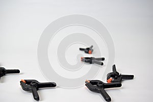 Close up concept black and orange spring clamping isolated on white background